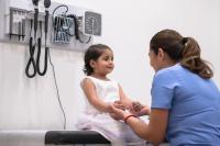 doctor and child patient holding hands